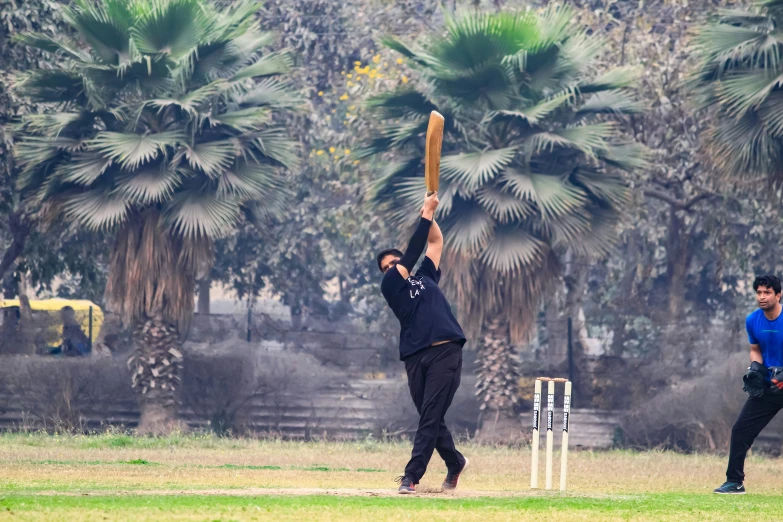 two people playing a game of cricket