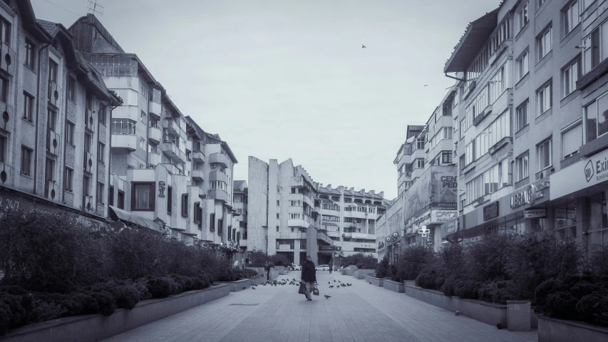 a city street filled with tall buildings on both sides