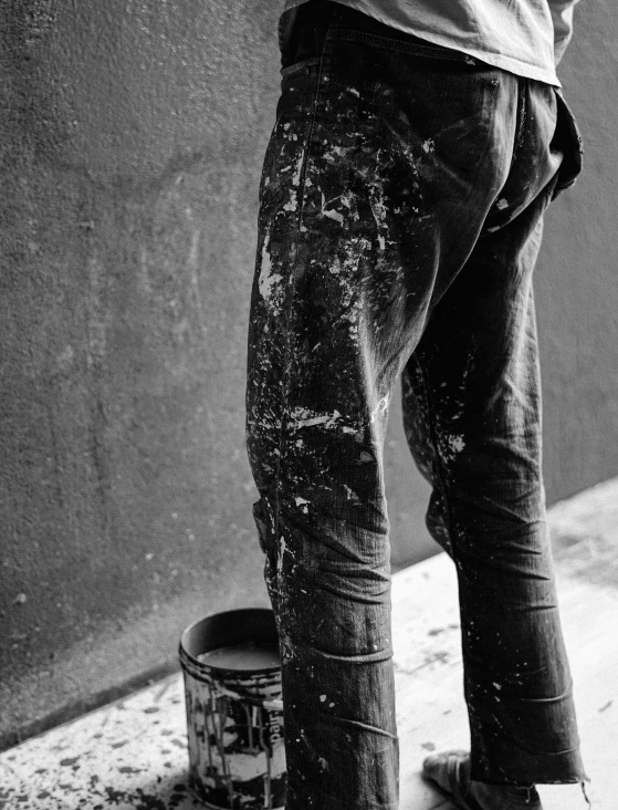 a boy with a beer in his hand is standing on the side walk