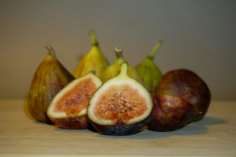 an arrangement of figs on a wooden table