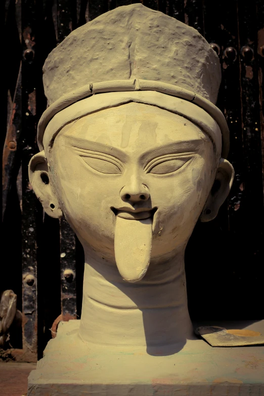 the large sculpture shows a sticking tongue out of its mouth