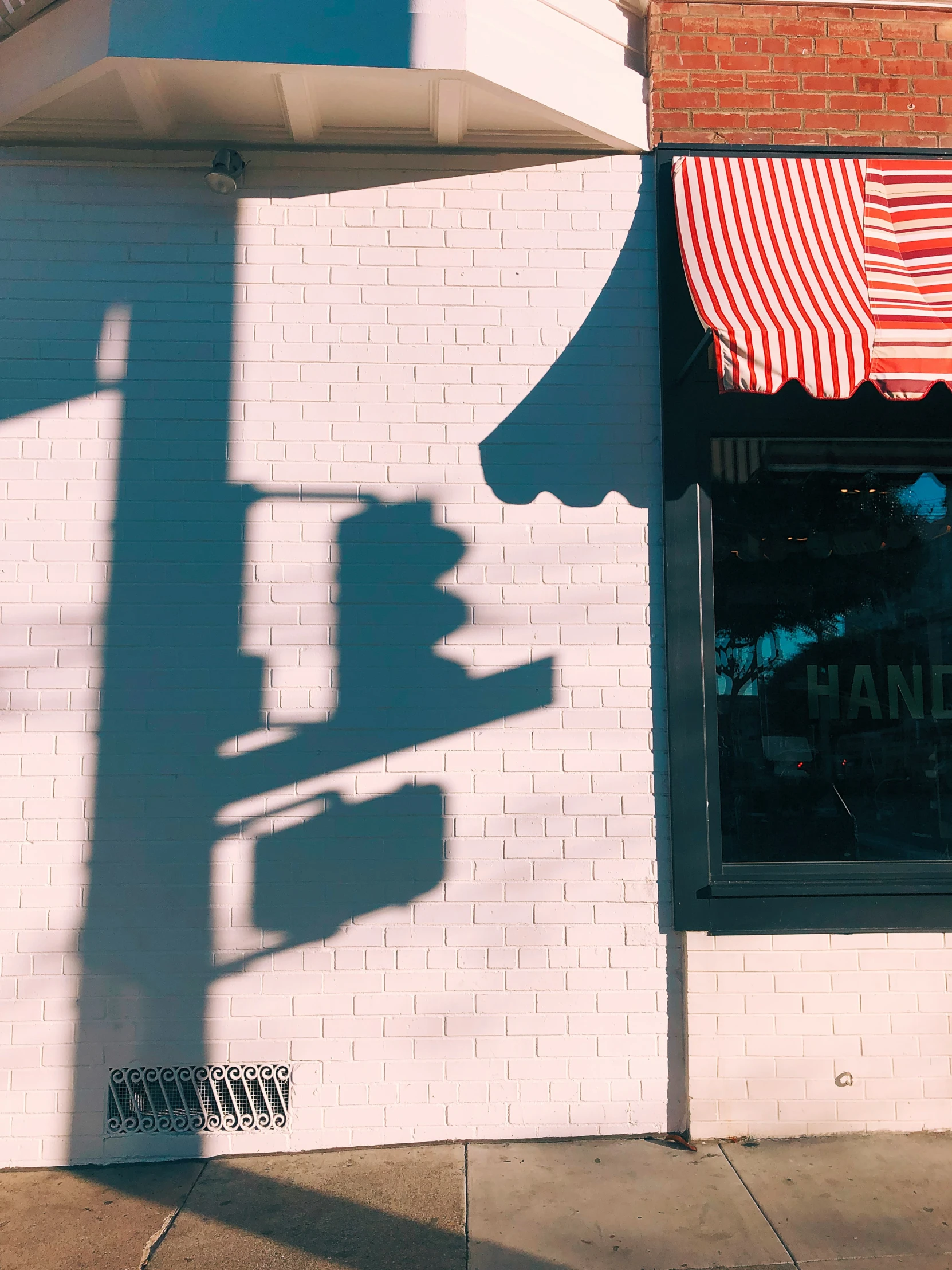 a red and white awning is on a building