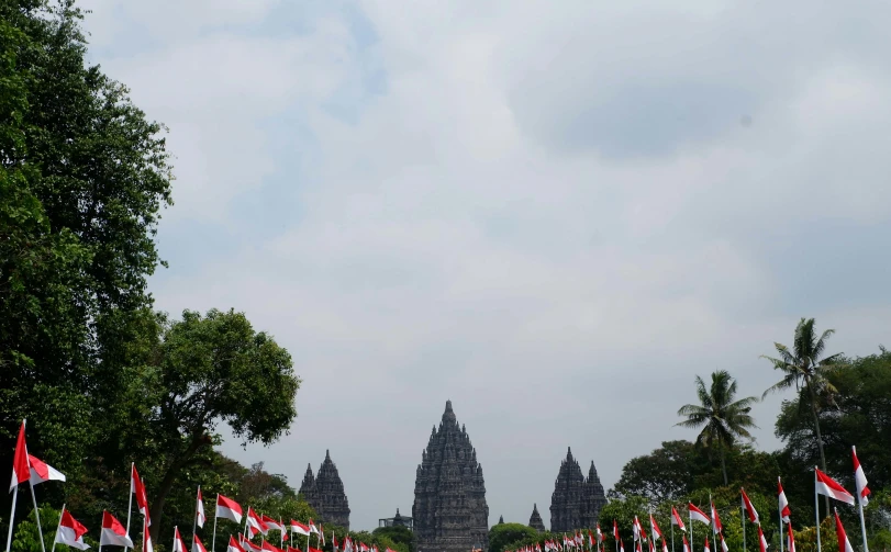 a large group of flags next to a tall building