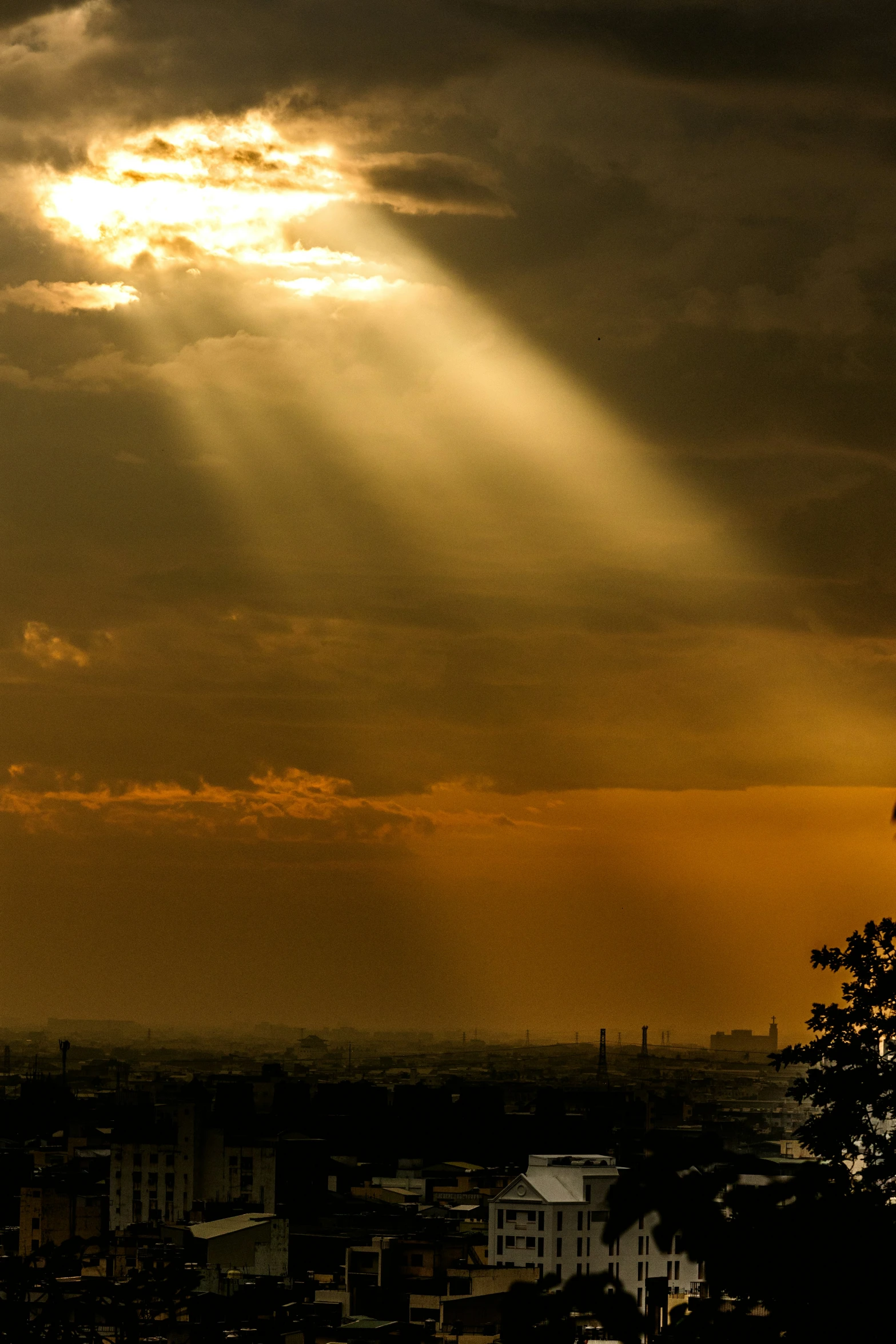 the sun shines through the clouds over a city