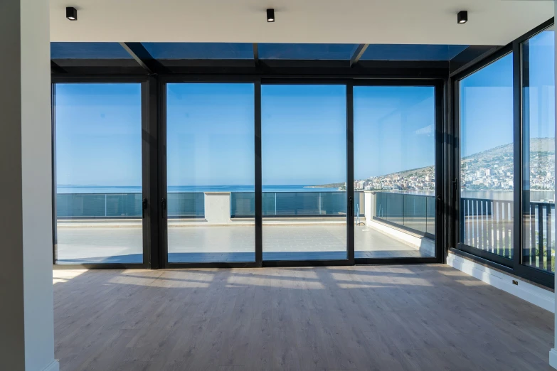 the interior of an apartment with windows that have panes to look out at the water