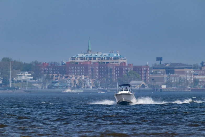 a motor boat on the water near a building