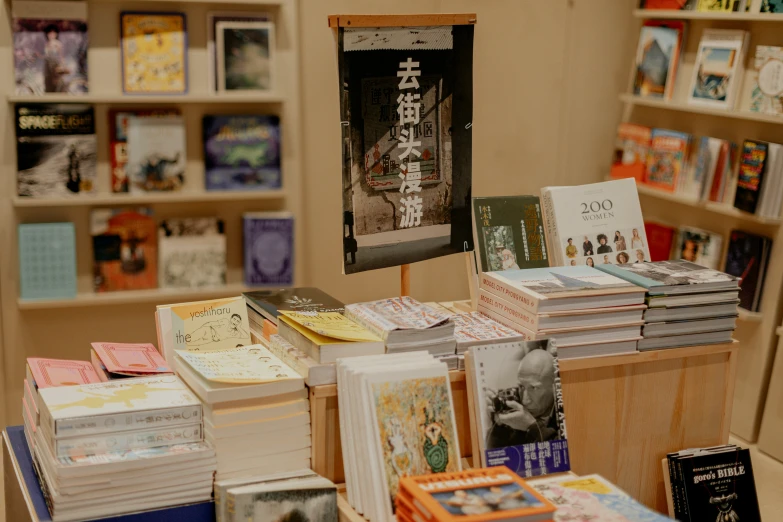 many books that are sitting on a wooden table