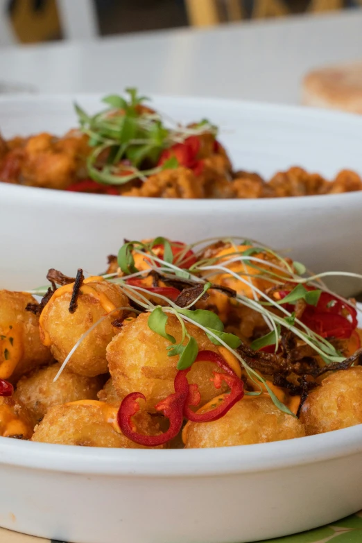 two bowls with different food items in them