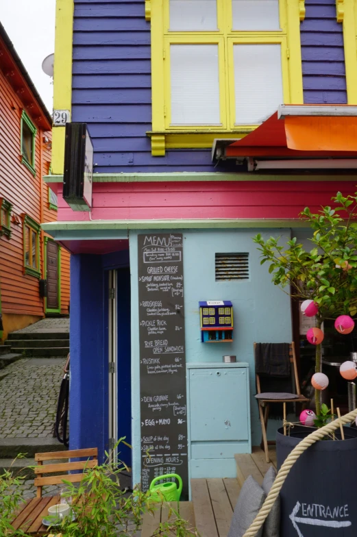 there is a small house with a chalkboard written on it