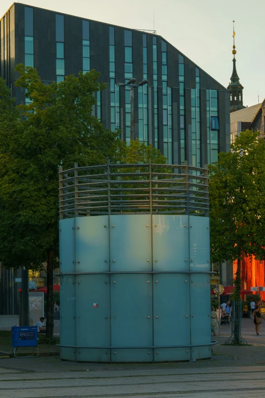 an empty bench in front of a tall building