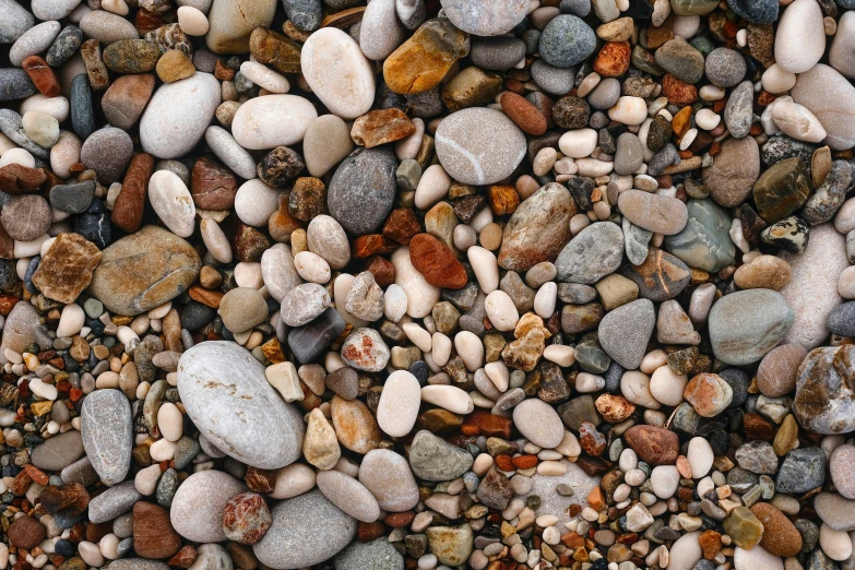a rock background has many different colored rocks