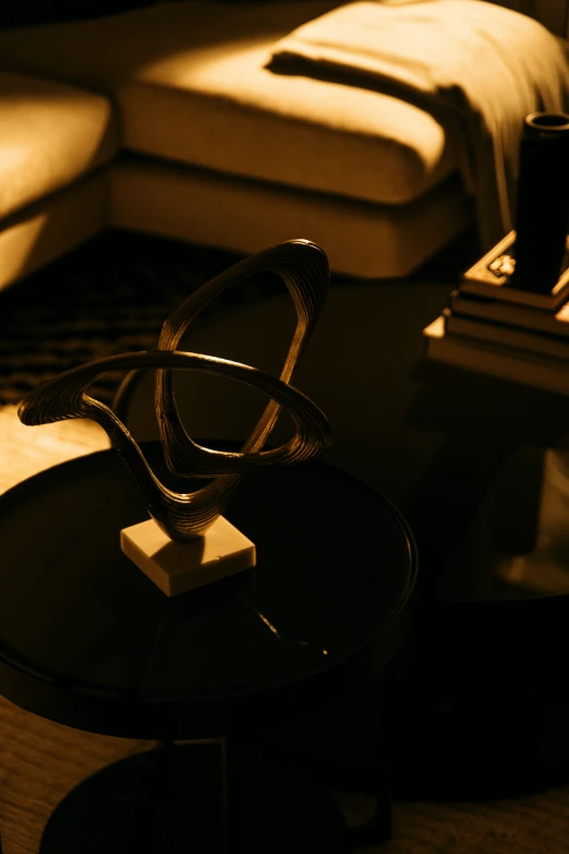 a dark room with a couch, table and chairs