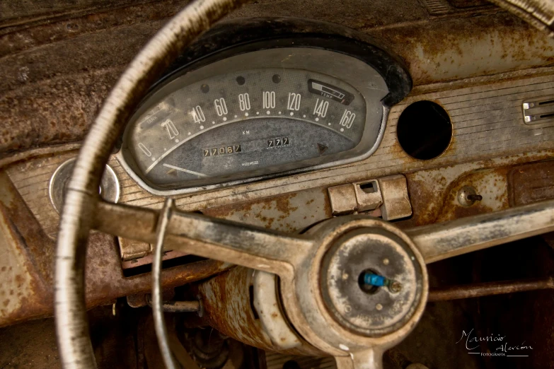 an old, dirty car with a speed limiter and gauges