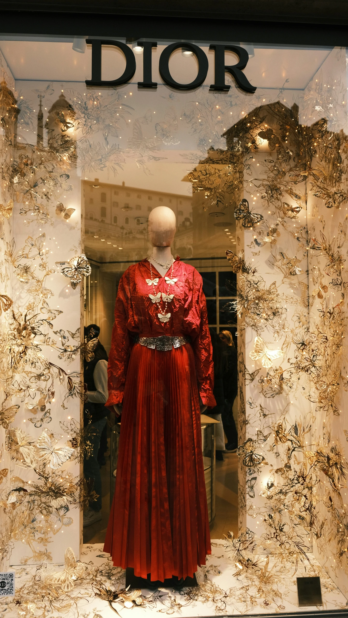 a red dress on display in a window