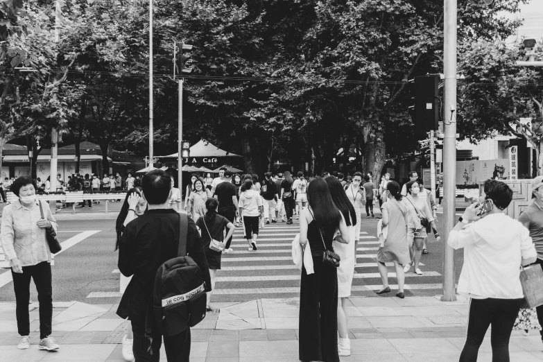 a group of people crossing a city street