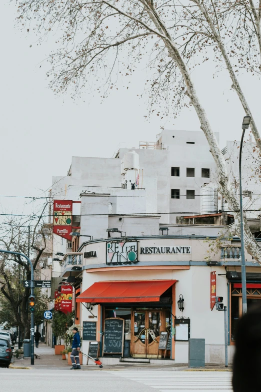 a street view of some buildings with signs on the roof