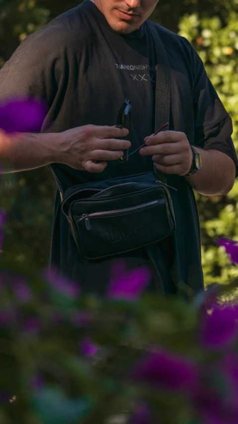 a man in sunglasses looking at his cell phone