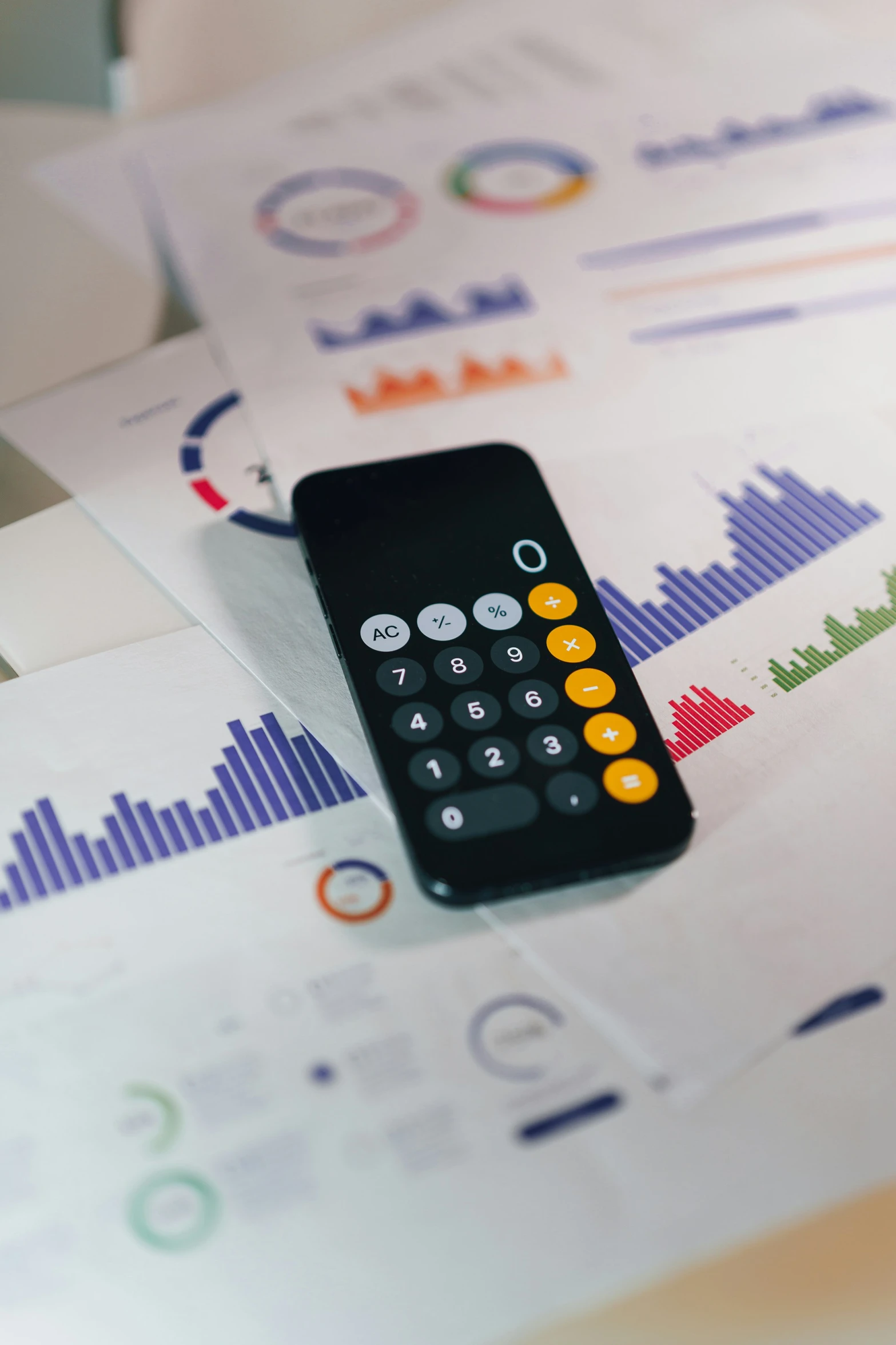 a remote sitting on top of a table surrounded by papers