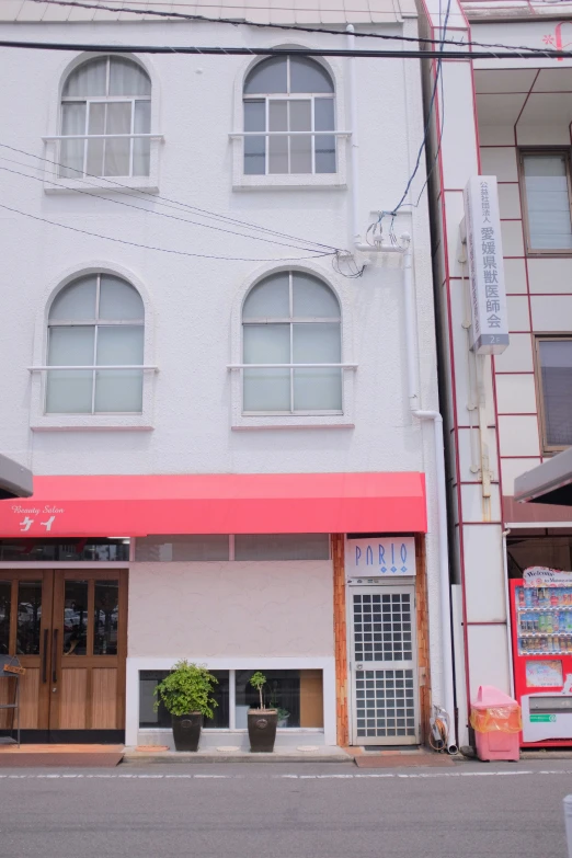 a large el with an awning and red door