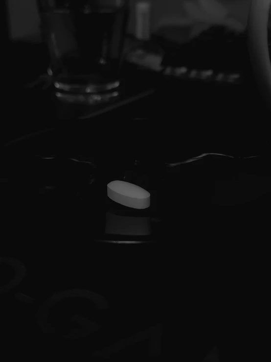 a glass of water sitting on top of a stove