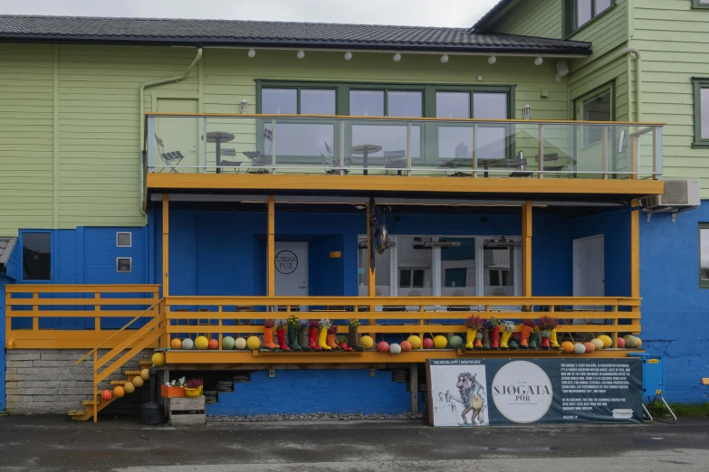 a brightly colored building has colorful stairs