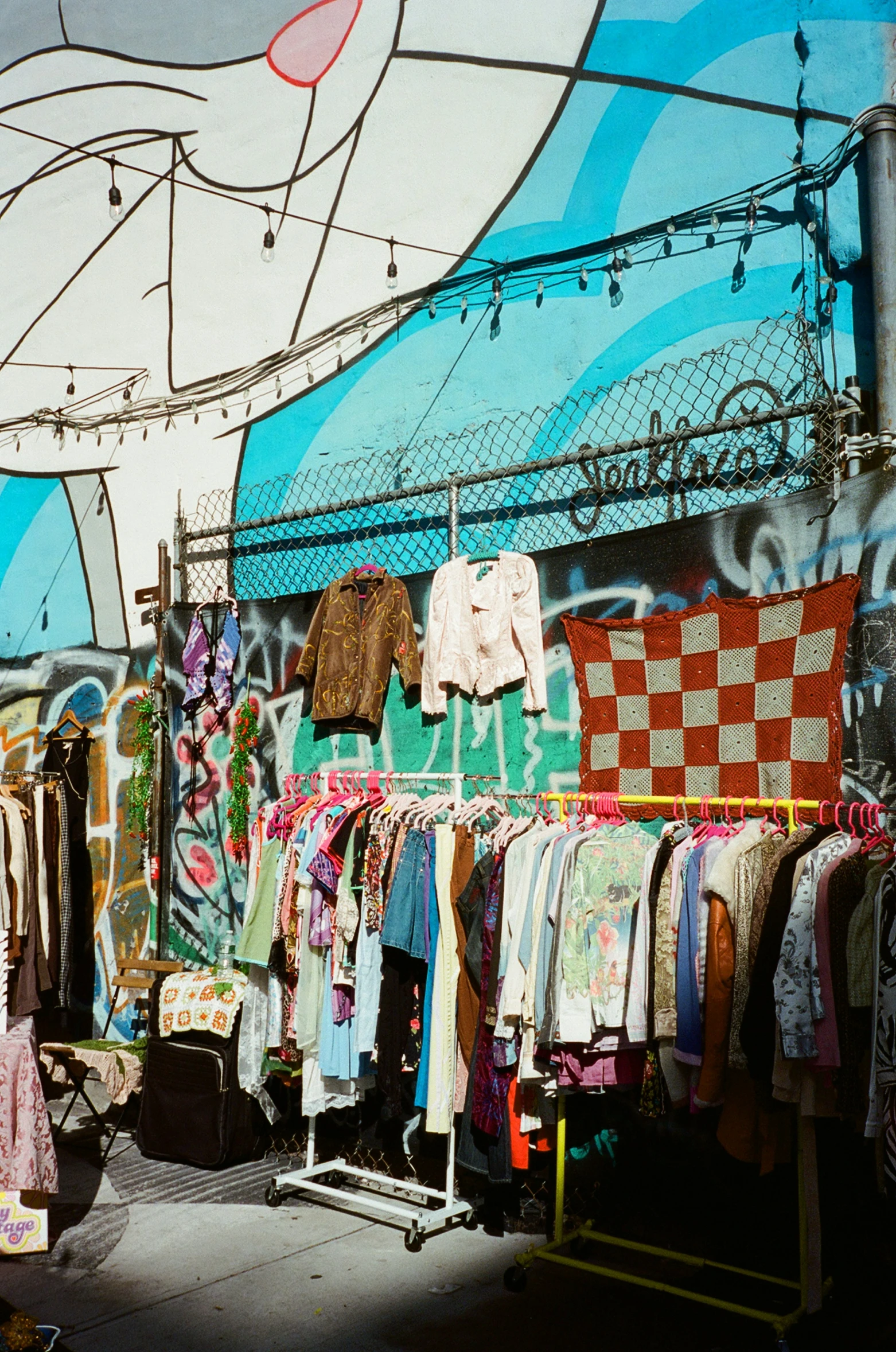 clothes hanging outside with a sign in the background