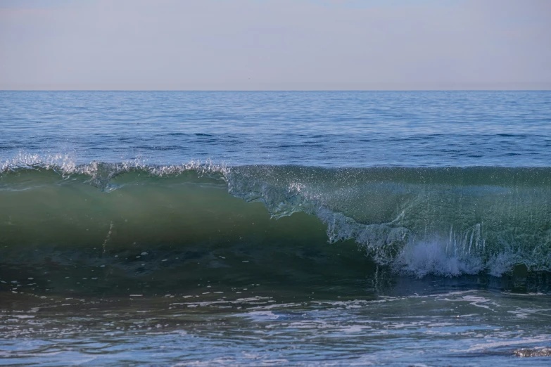 waves crash on the ocean near the beach