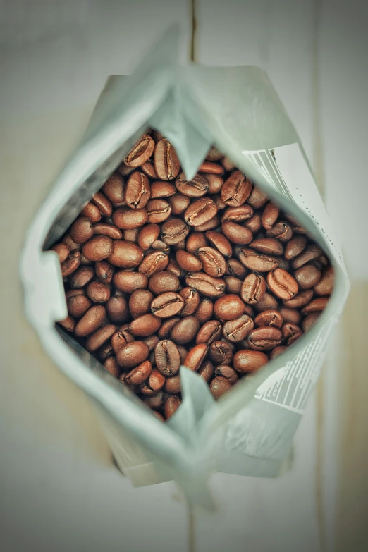 coffee beans sit in a large plastic bag