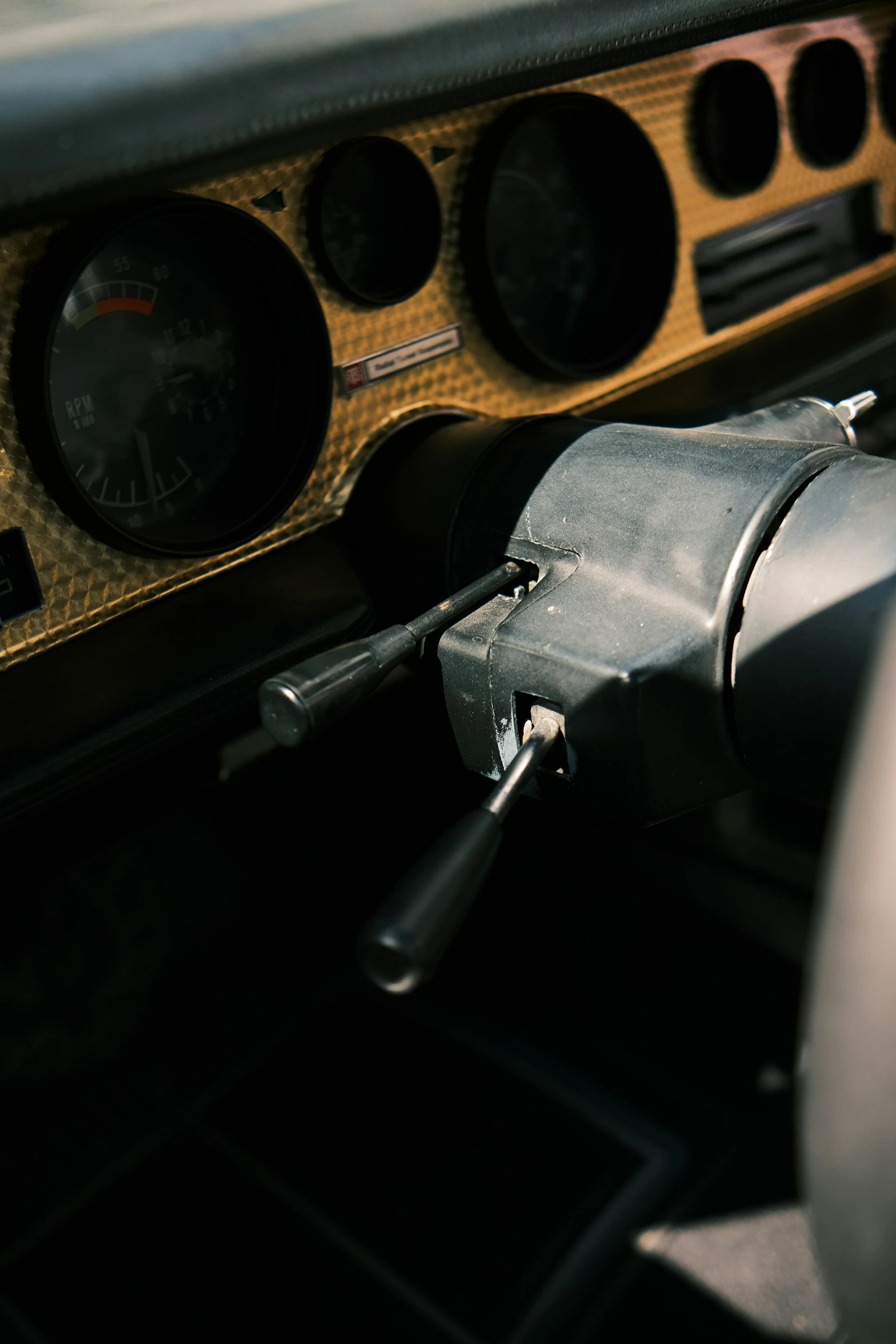 dashboard area of an automobile with several gauges