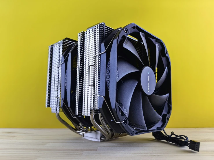the intel processor and fan are displayed in front of a yellow wall