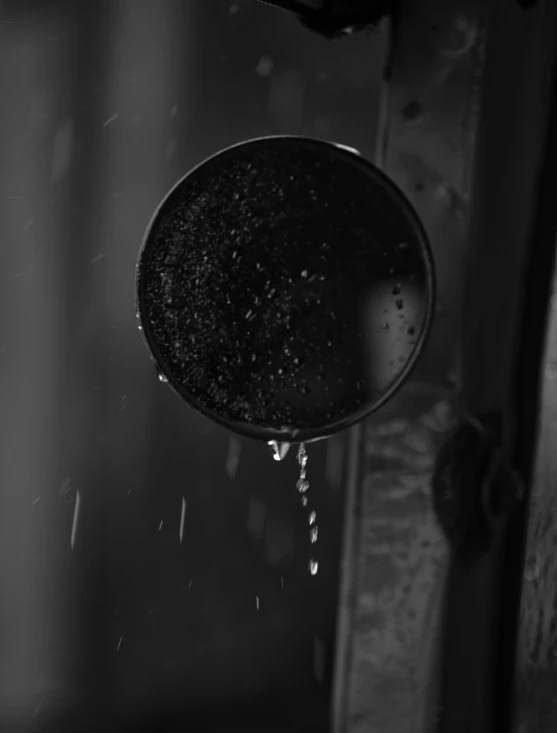 the reflection of a person's hand with water pouring from it