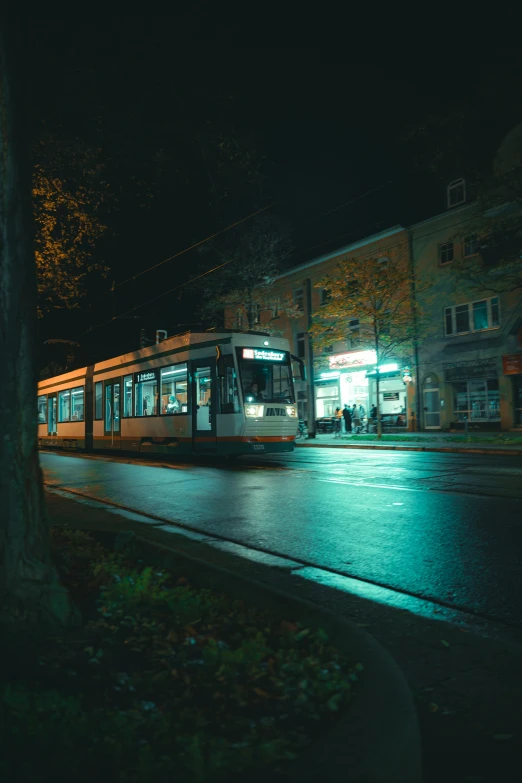 a trolley on tracks at night in the city