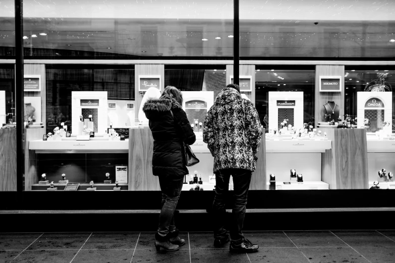 two women look at bottles in the windows