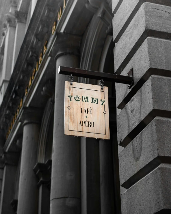 a sign hanging outside the entrance to an old building