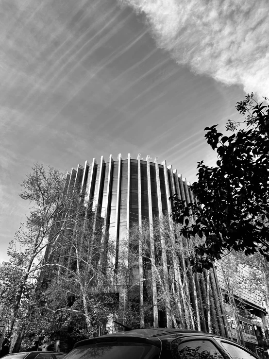 a tall building with many trees near it