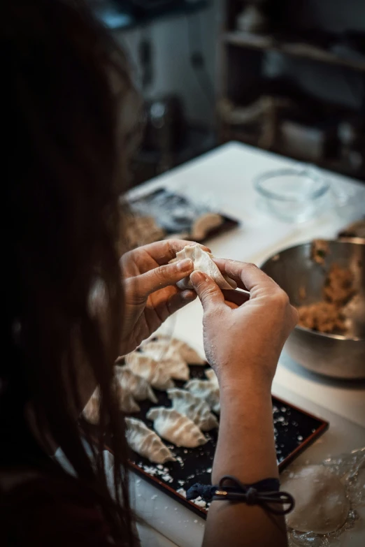 woman putting ers in plate on table