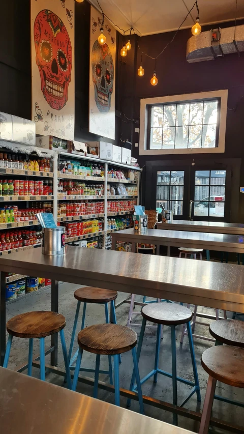 a restaurant with tables in the middle and many shelves