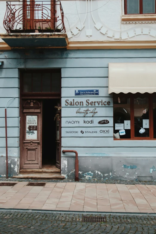 a salon is seen on a building across the street from it