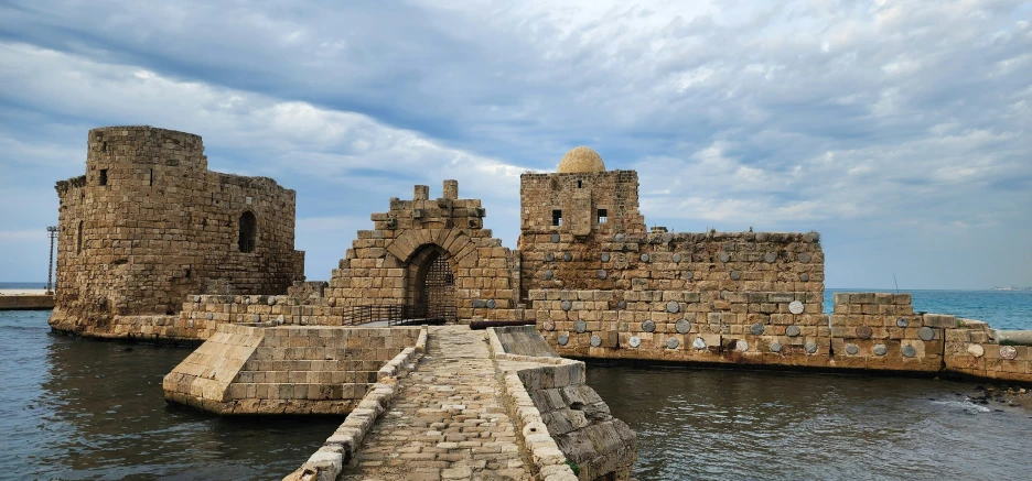 the moates of a stone castle on a beautiful cloudy day