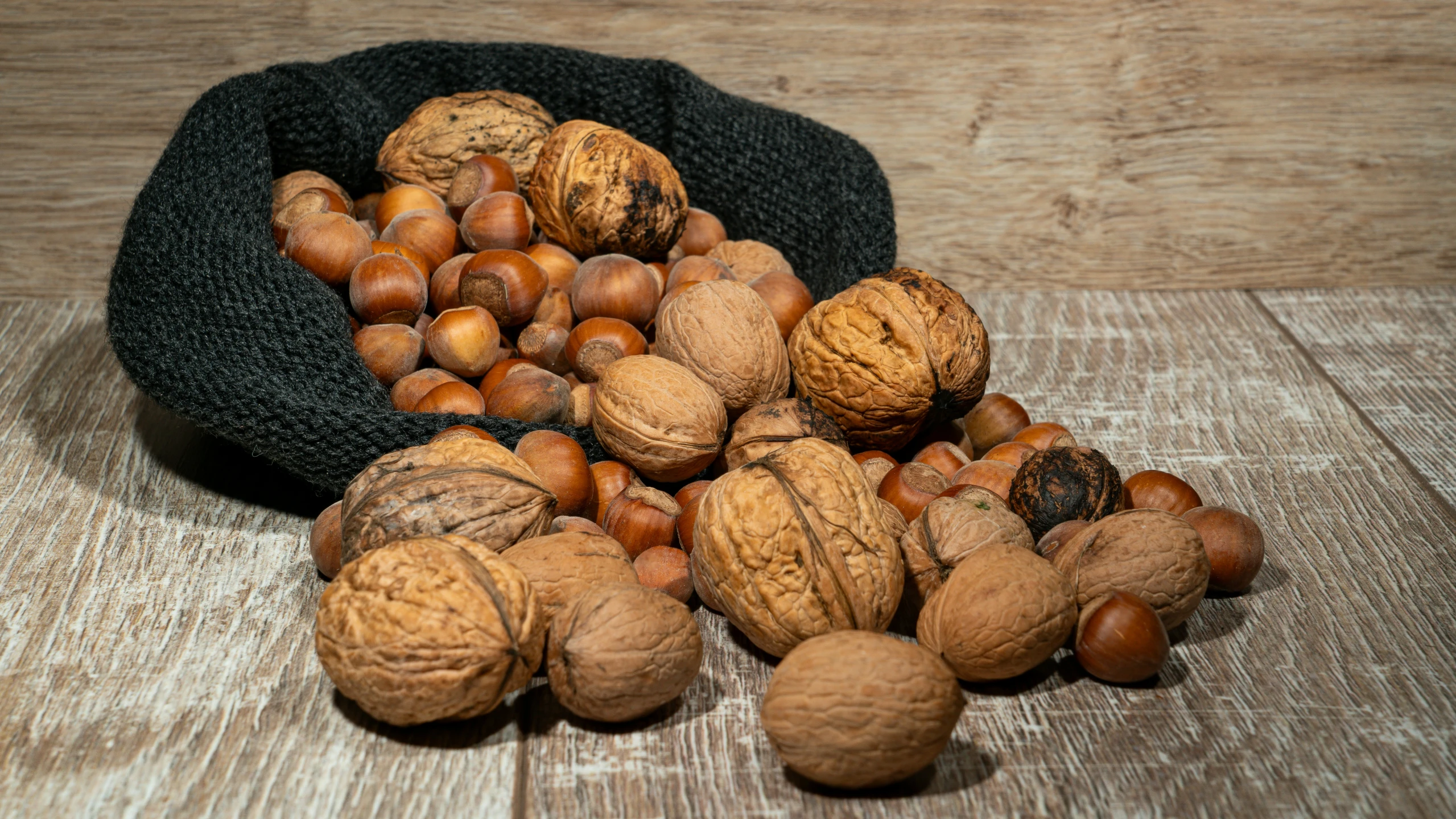 a bag filled with walnuts and other nuts on top of a table