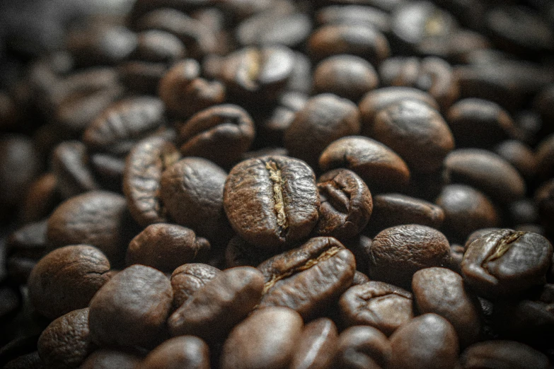 a close up of coffee beans with some white and brown on them