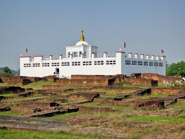 a large white building with towers in the distance