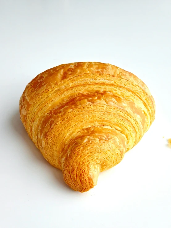 a piece of croissante on a white table