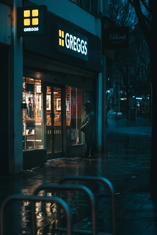 an empty street with an entrance to griegs on the right