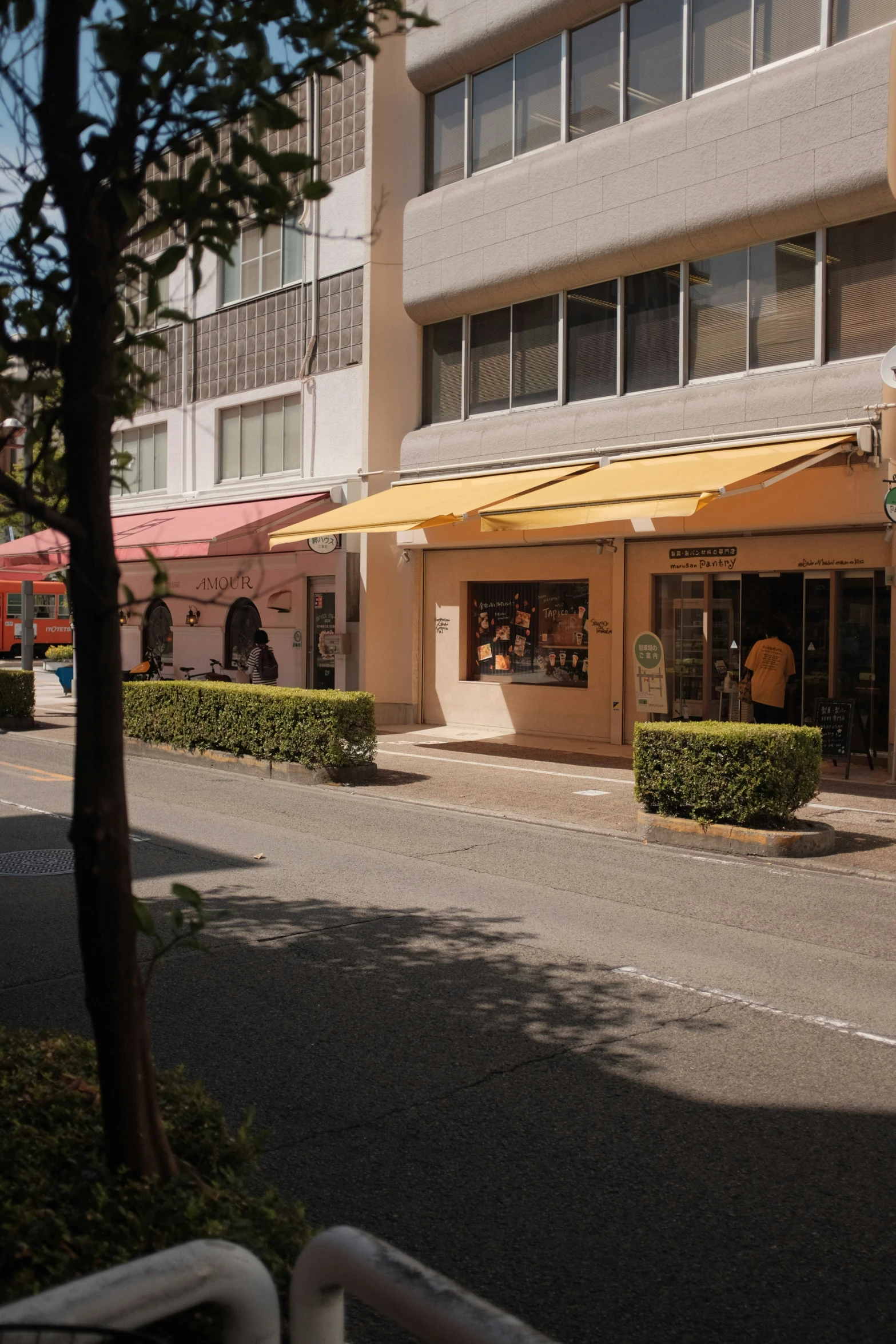 a store with awnings on a city street