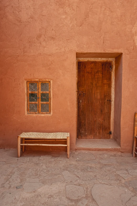 an empty bench and some old looking windows