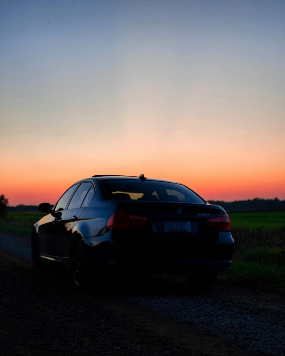 a black car parked on the side of a road