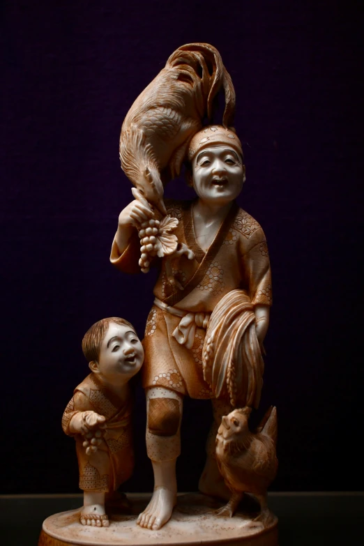 a carved sculpture of a child and a bird on a wood stump