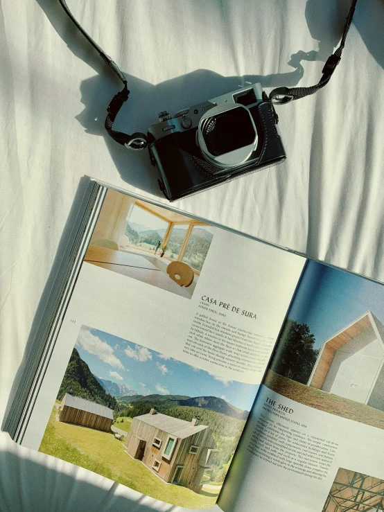 an open book is laying on top of a bed