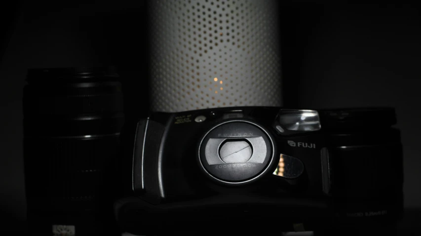 camera and some cans are sitting on a table